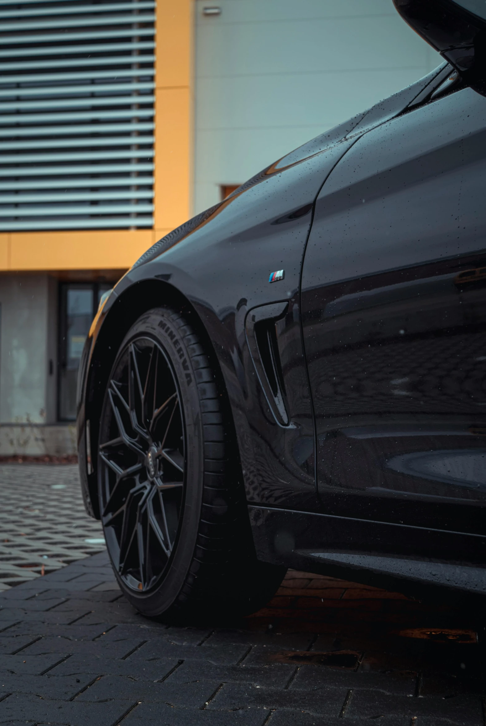 the wheel on the black sports car is facing sideways