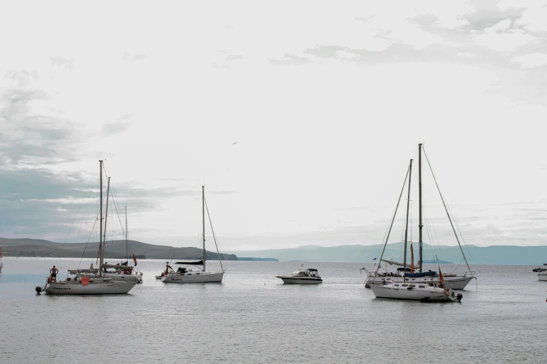 the sail boats are traveling on the large body of water