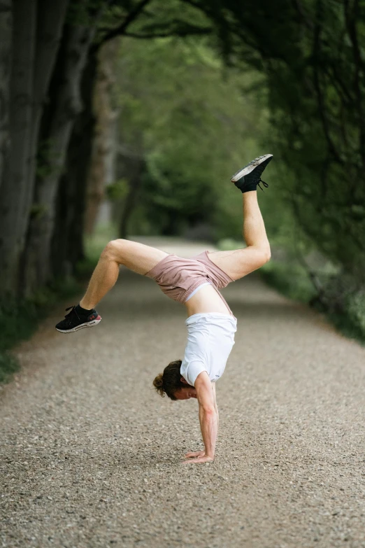 a man who is doing a hand stand
