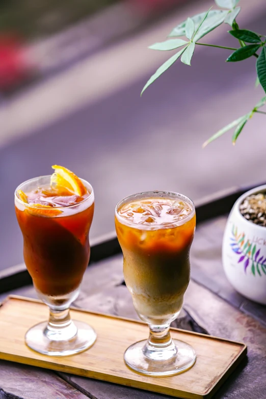 two glasses of different types of drink on a tray