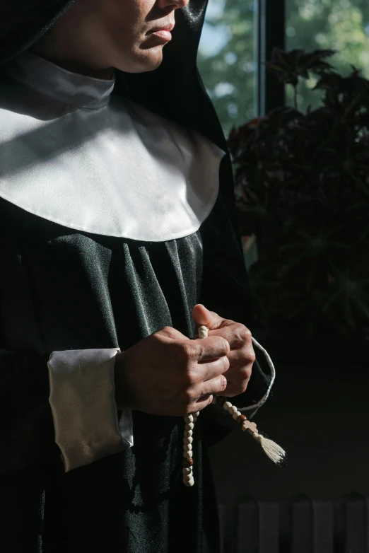 a woman in nun robes with an open book