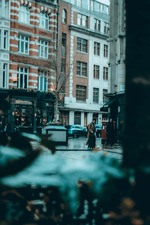 a person walking on the street in front of several buildings