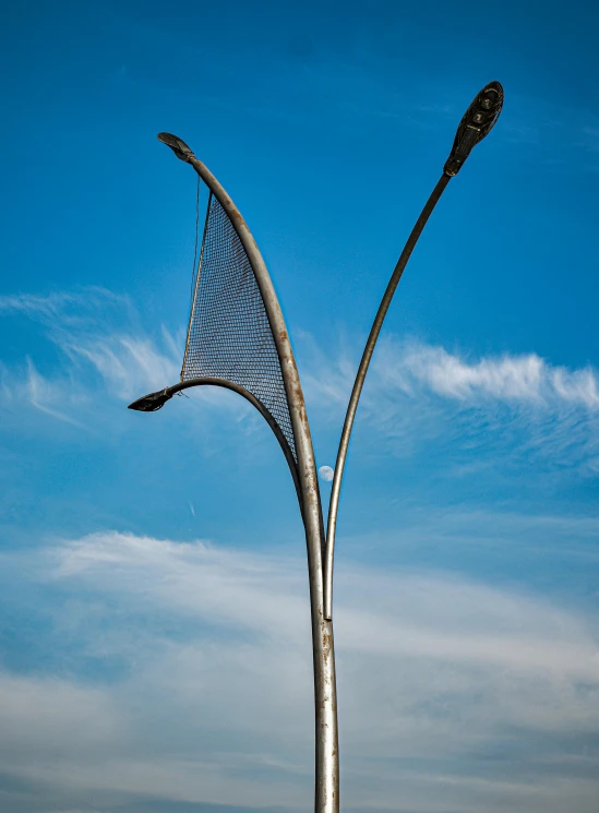 a large metal sculpture sitting on the side of a road