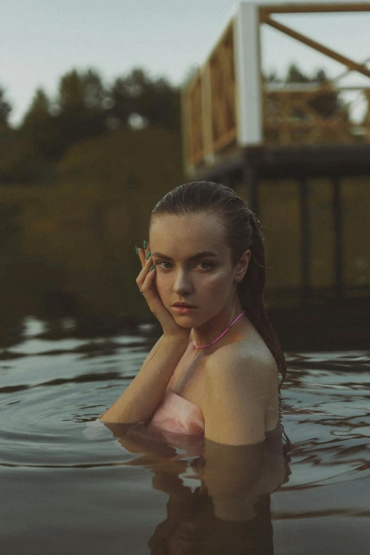 a woman is floating in the water with a cell phone