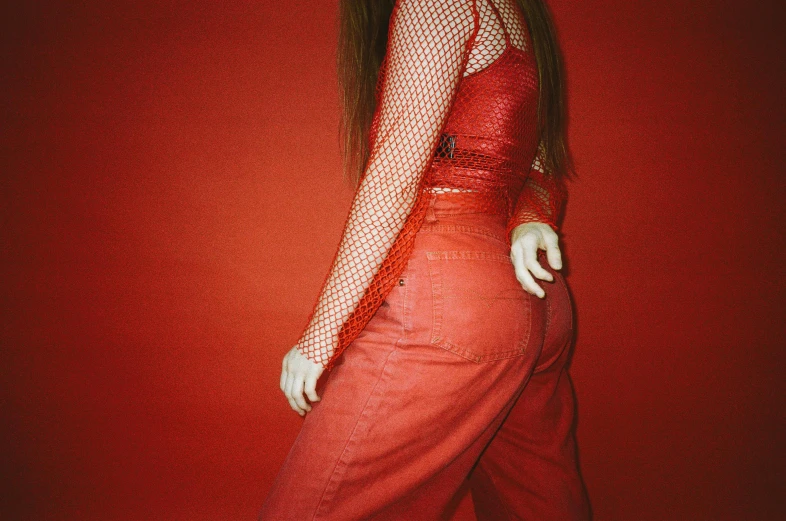 a woman in red posing on a red wall