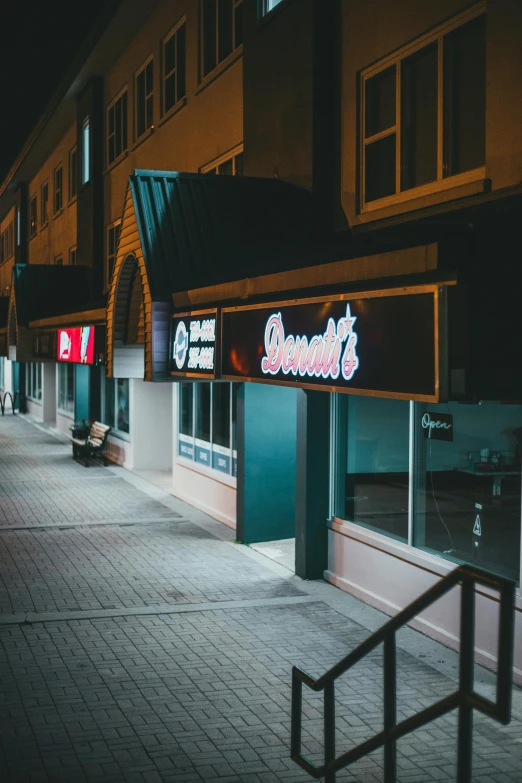 empty sidewalk and buildings in a city at night