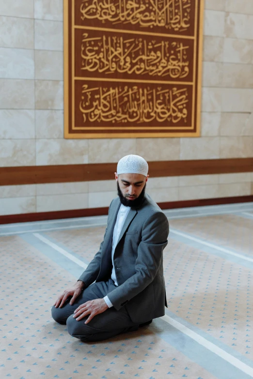 a man kneeling down in the middle of a room