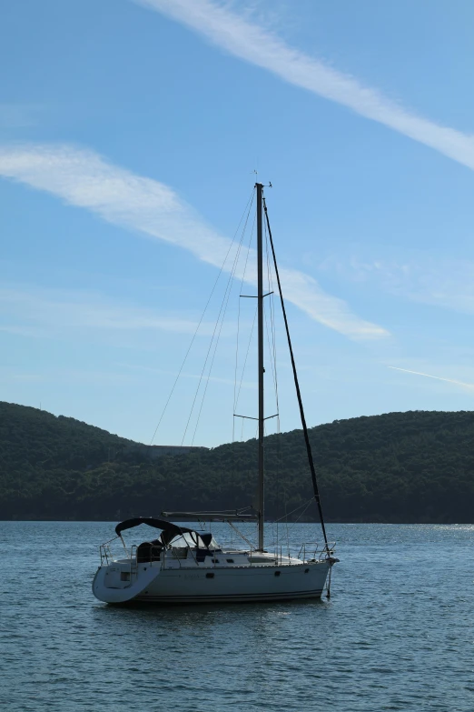 a sailboat floating in the middle of the ocean