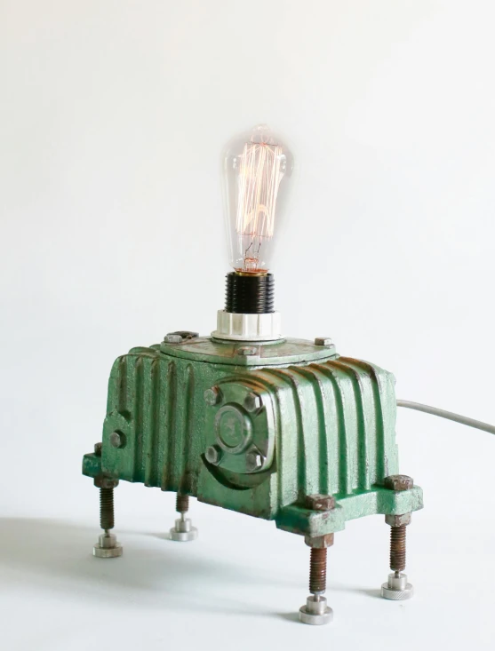 a lamp is turned to look like a green robot