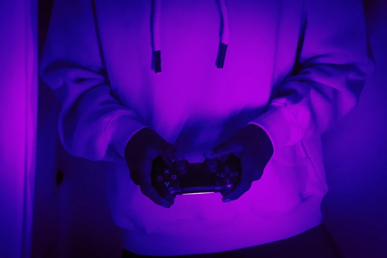 a person holding a game controller in their hand