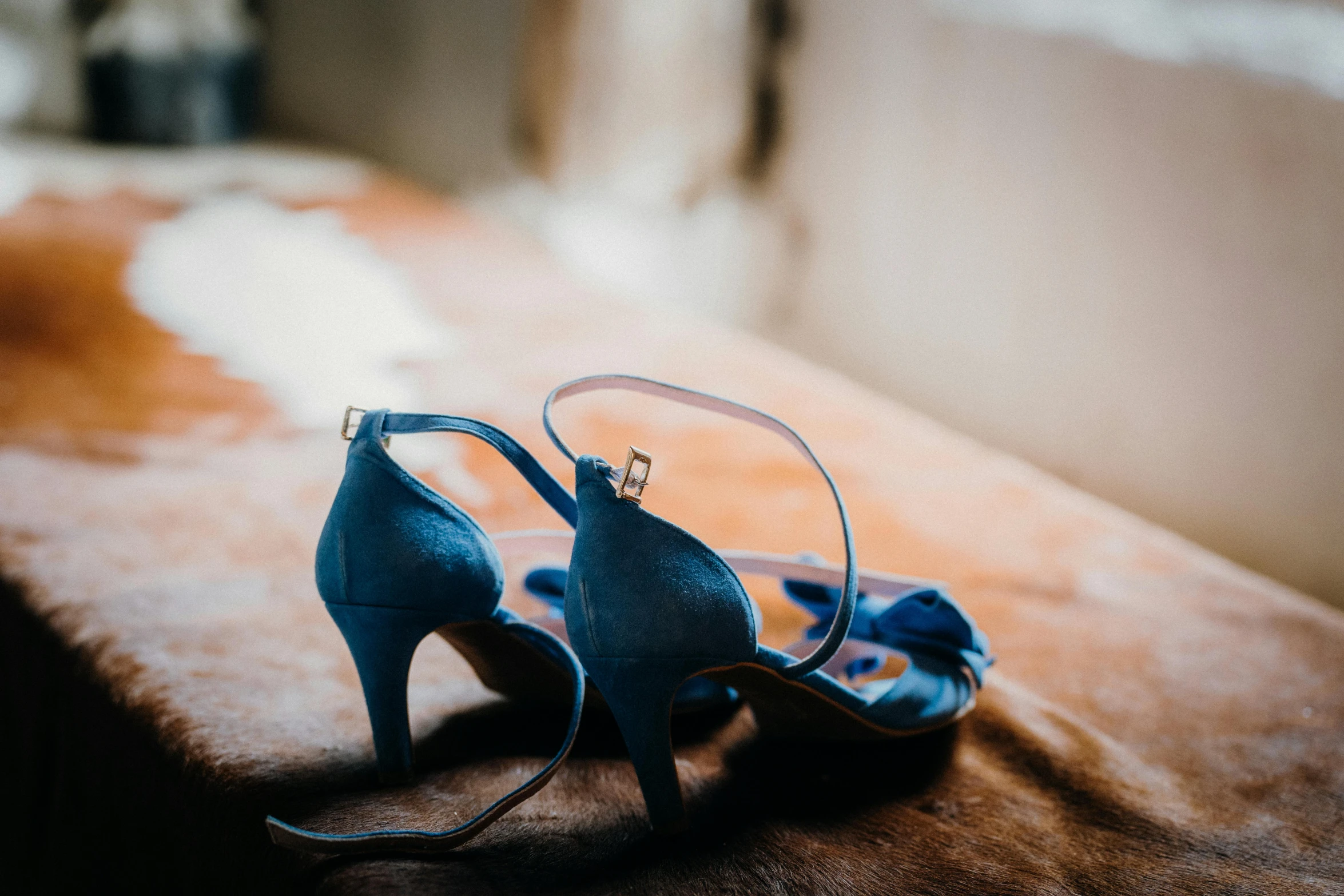 the woman's high heel shoes are on the table