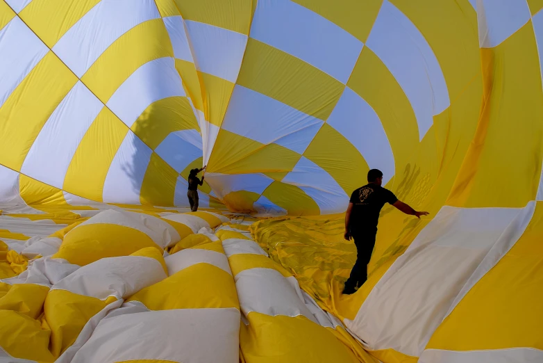 people stand inside a large  air balloon