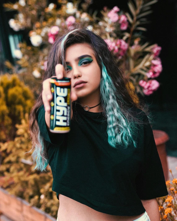 a young woman wearing minty mint green hair is holding a green apple juice