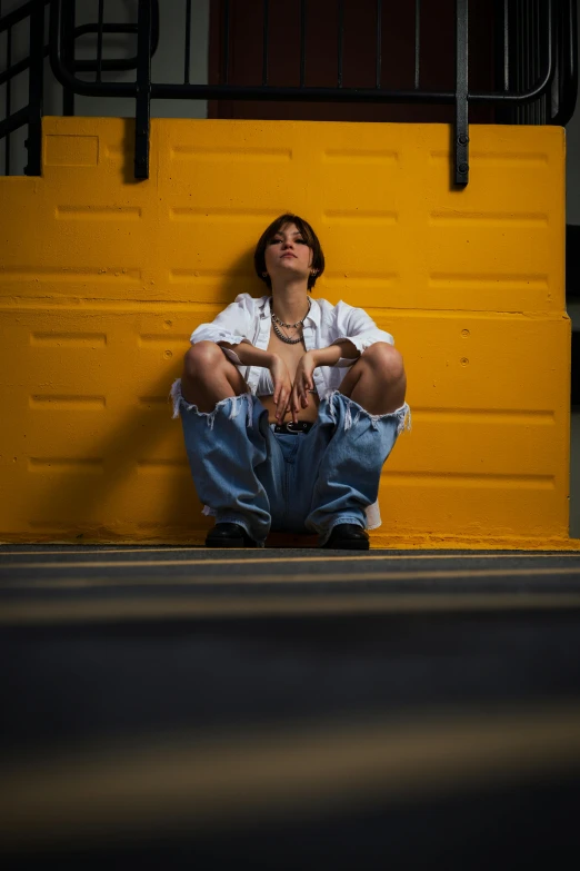 a woman sits on the ground with her legs crossed