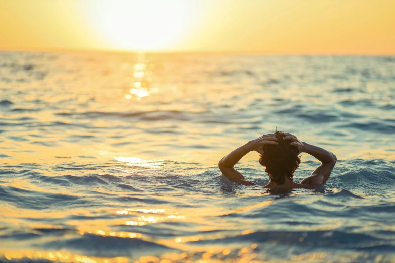 a person in the water wearing a swimsuit