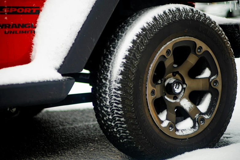 snow covered tire on a flatbeded vehicle
