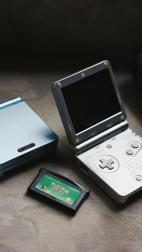 an ipod and a game system sitting on a bed