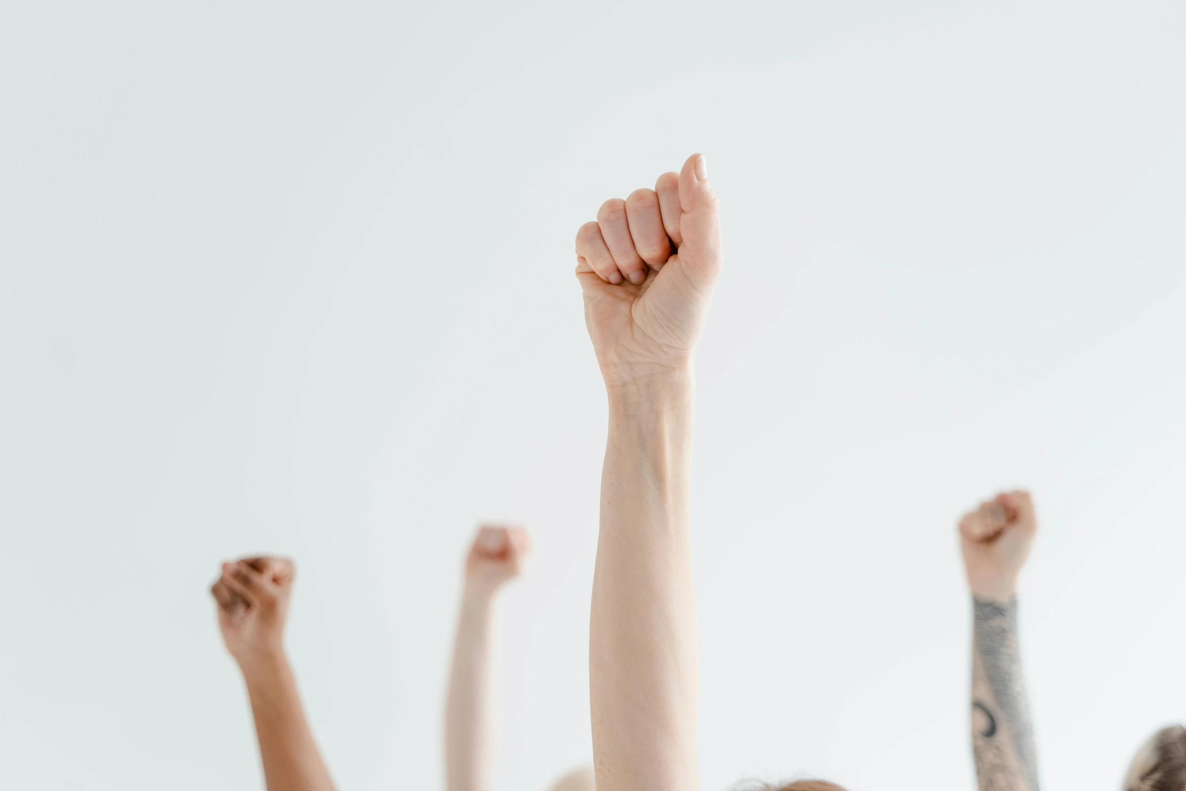 a group of people with their arms up with raised hands