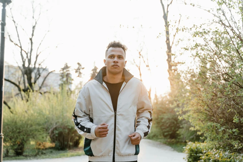 a man walking down the road in his jacket