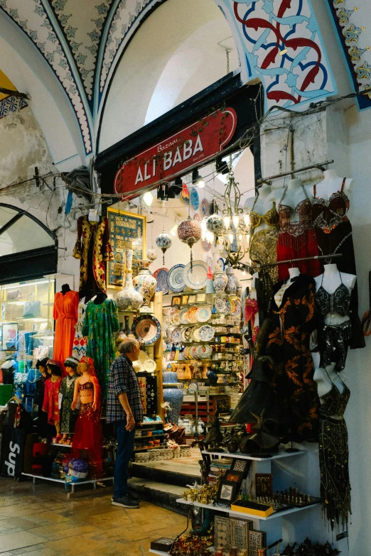 a man walking through an open area in front of a market