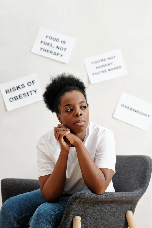 the woman is looking pensively sitting in the chair