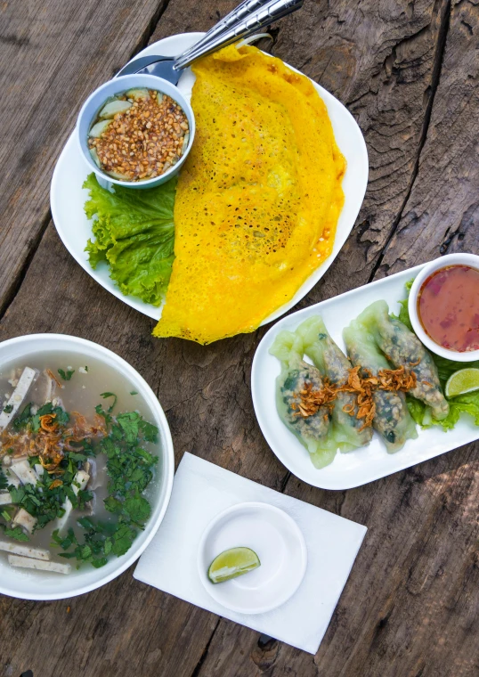 three plates of food on a wood table