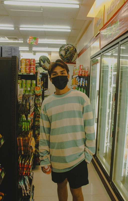 a person in a mask stands inside a grocery store