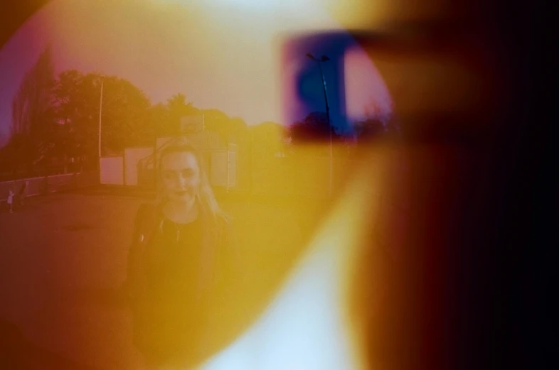 a closeup of a person's face behind the door