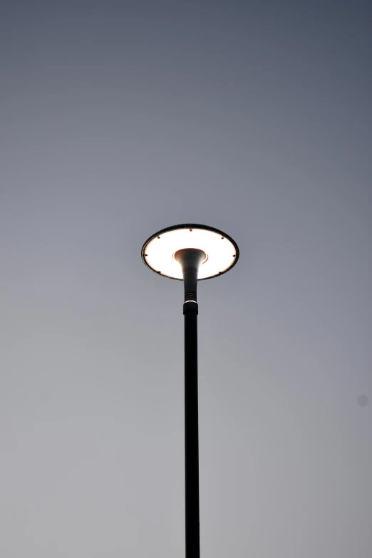 a street light pole with a sky background