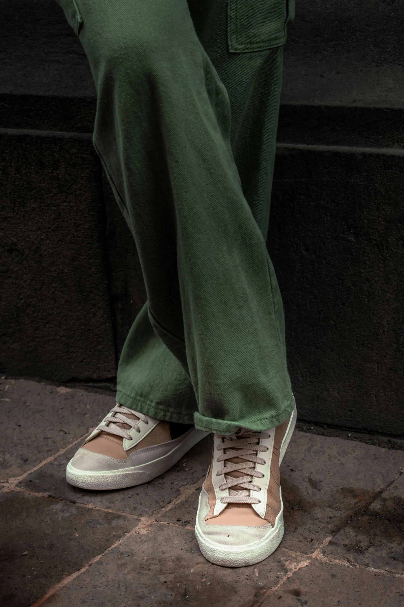 a person standing on the street wearing green pants