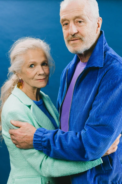 a man and a woman are posing for the camera