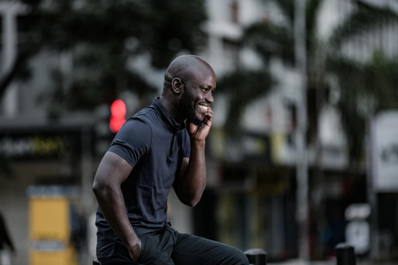 a man standing outside while talking on his cell phone