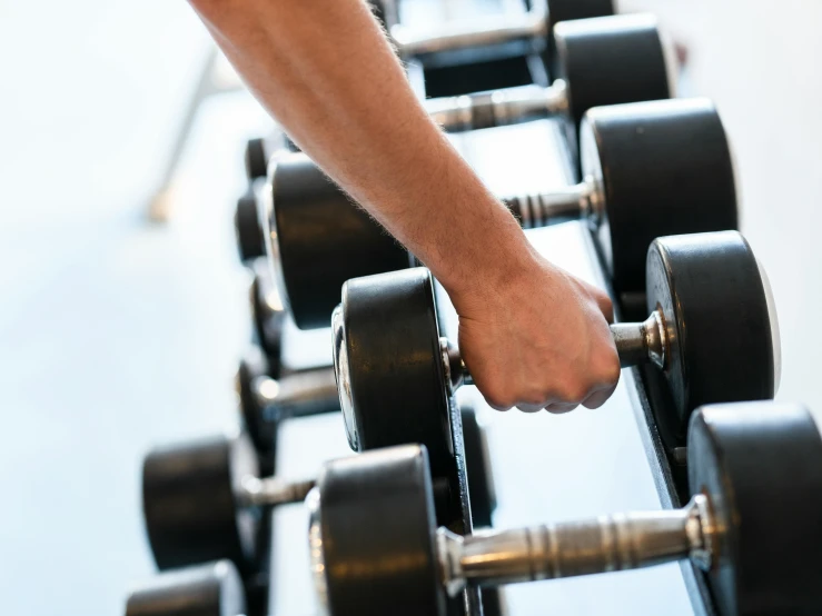 someone pressing dumbbells on an exercise machine