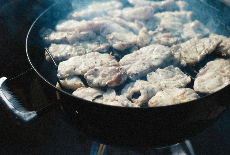 some food is cooking in a large pan on the stove