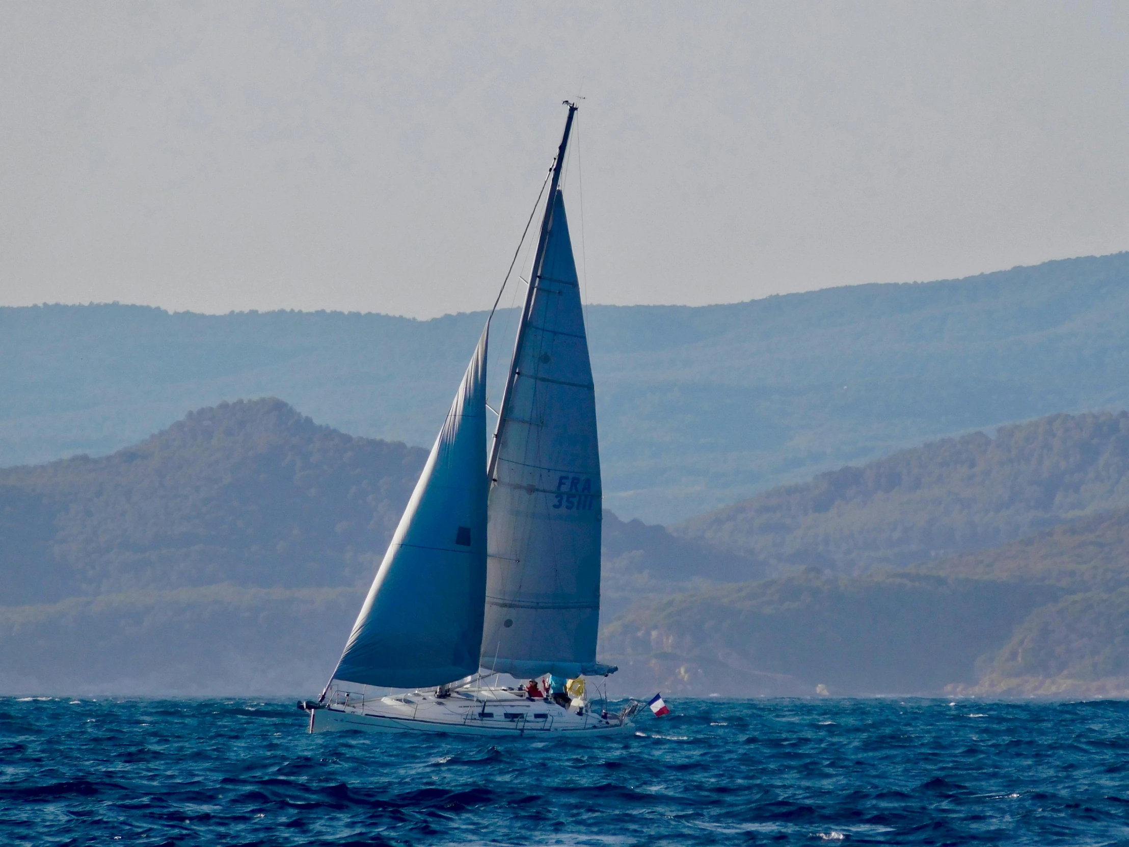 the sailboat is moving through the open ocean