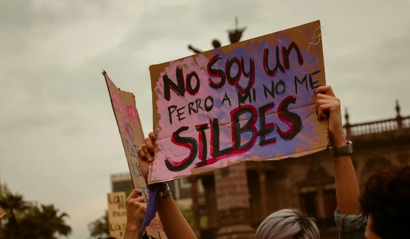 a group of people protesting and holding up signs