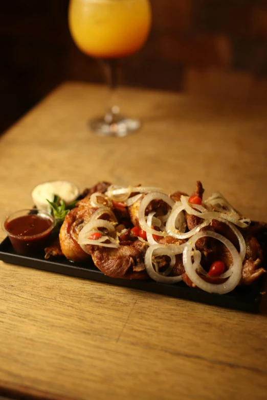 some food sitting on a plate with wine next to it