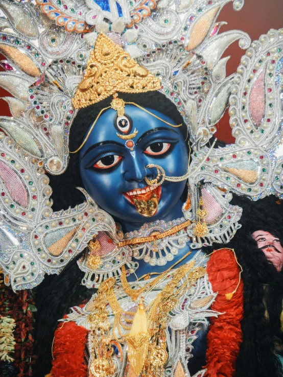 the colorful costume of a woman wearing an elaborately designed mask