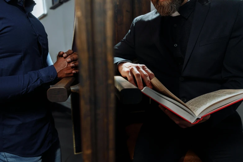 a man holding an open book in his hands