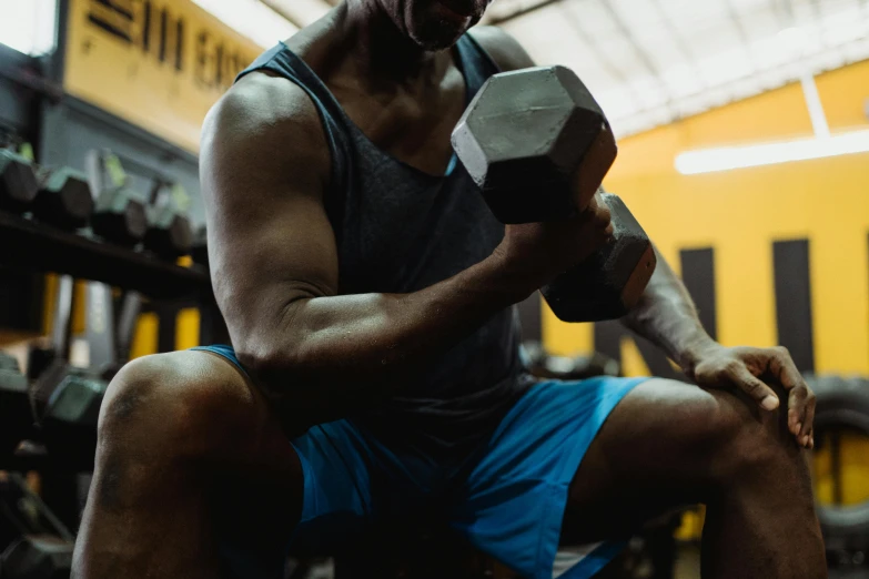 a muscular man with his fist up in a gym