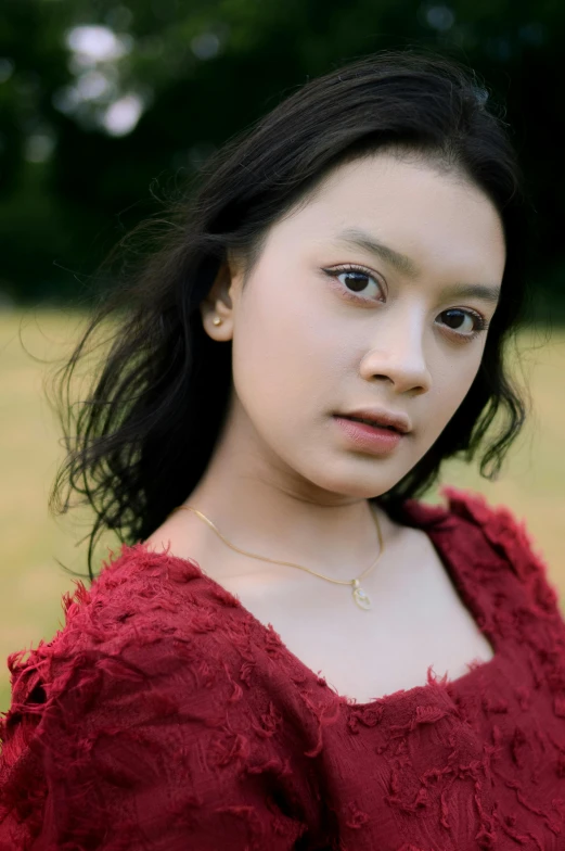 young asian woman in a dress poses for a portrait