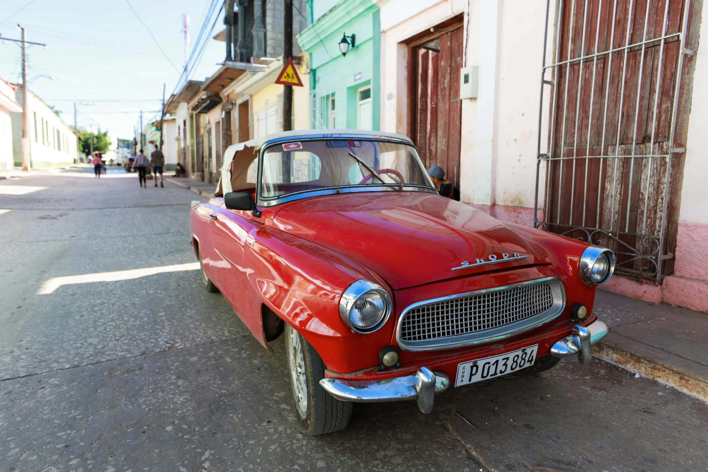 an old car is parked next to the curb