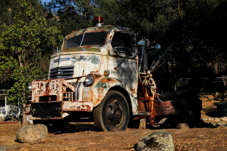 an old rusty truck with a horse trailer