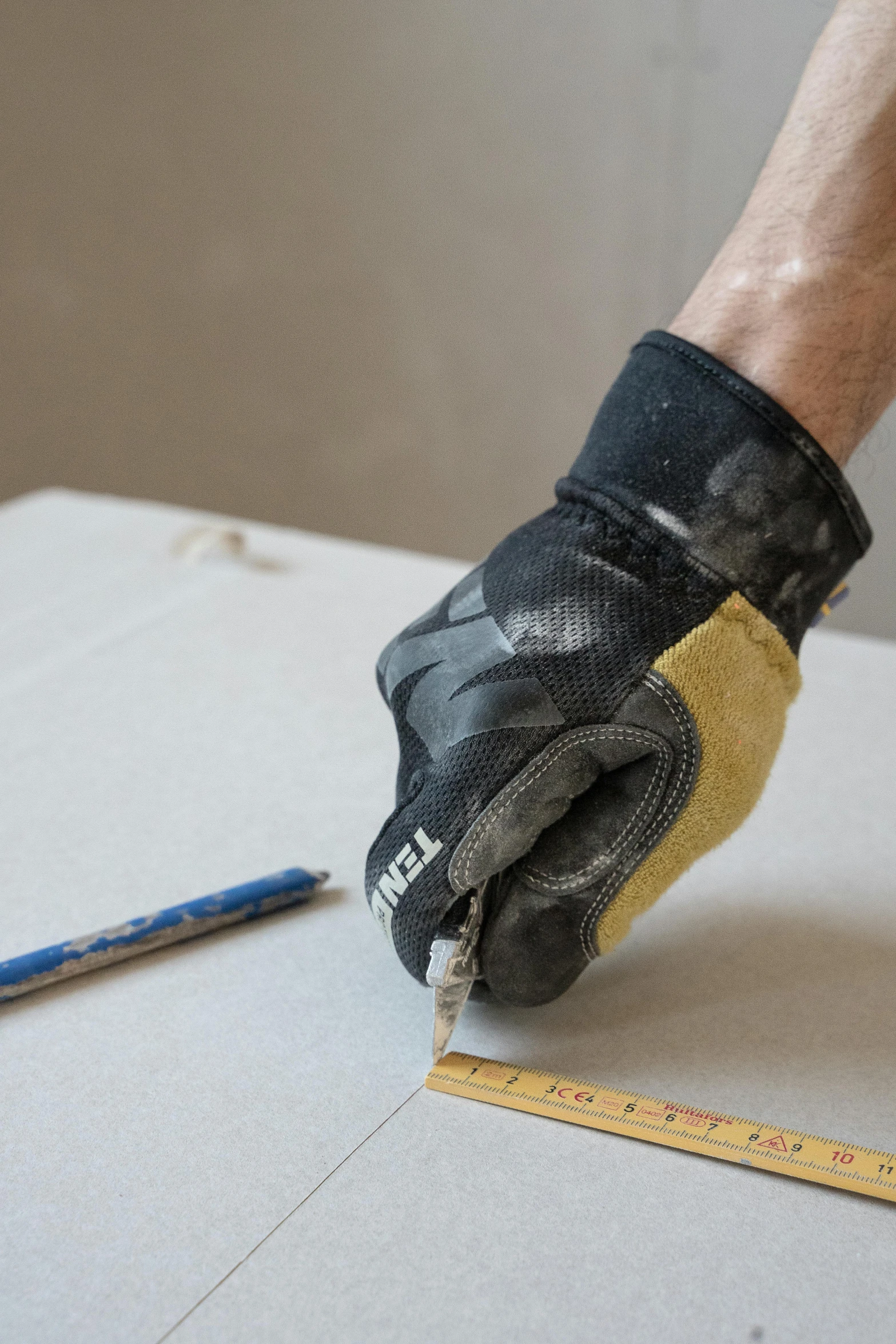 someone using a large glove to work on the floor