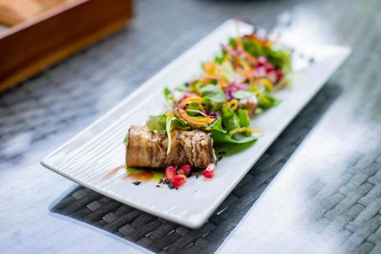 a white plate filled with food sitting on top of a wooden table