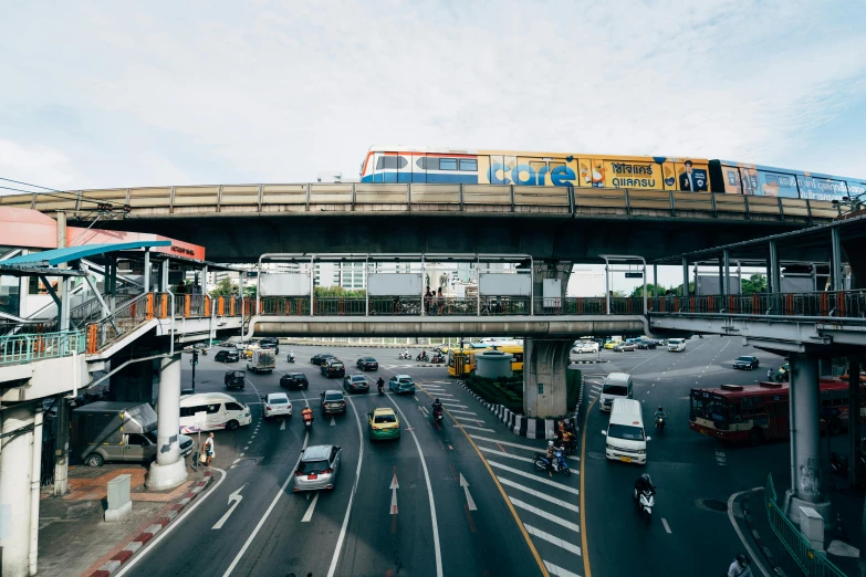 train on elevated elevated bridge above roadway and intersection