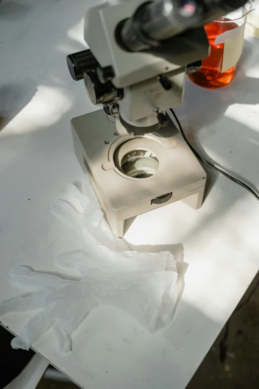 a microscope is shown next to tissue on a table