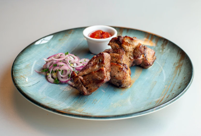 a dinner plate with meat on a fork, slaw and marinara sauce