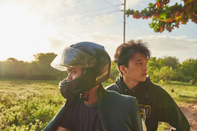 two young men who are standing on their bikes