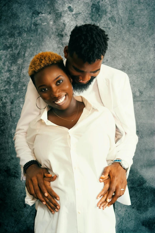 an attractive african couple is posing for the camera